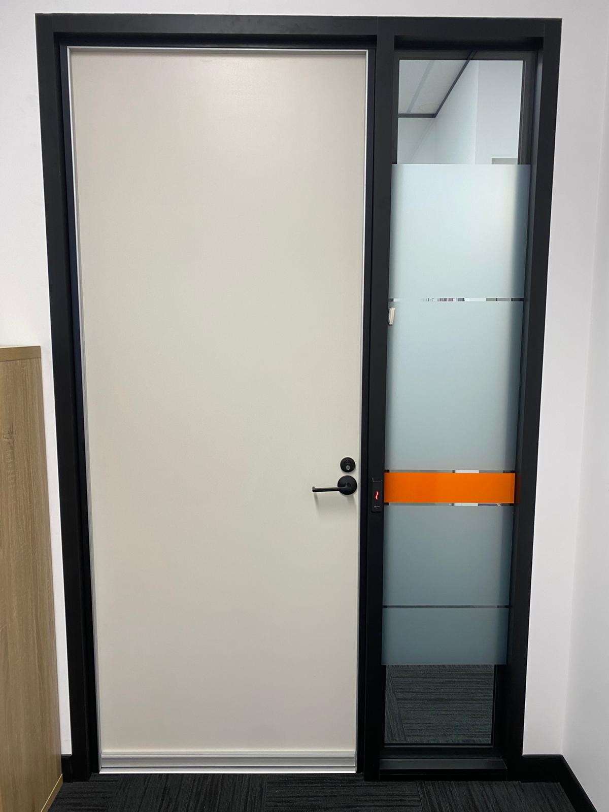 Acoustic door with glazed sidelight — office fit-out