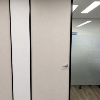 Custom made acoustic RW36 door in a black frame beside frosted glazing at Mining Services Australia, Perth