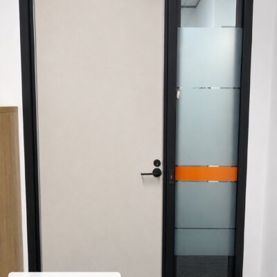 Custom made acoustic RW36 door in a black frame with 10.5mm VLam Hush secondary glazing sidelight at Naala, Perth